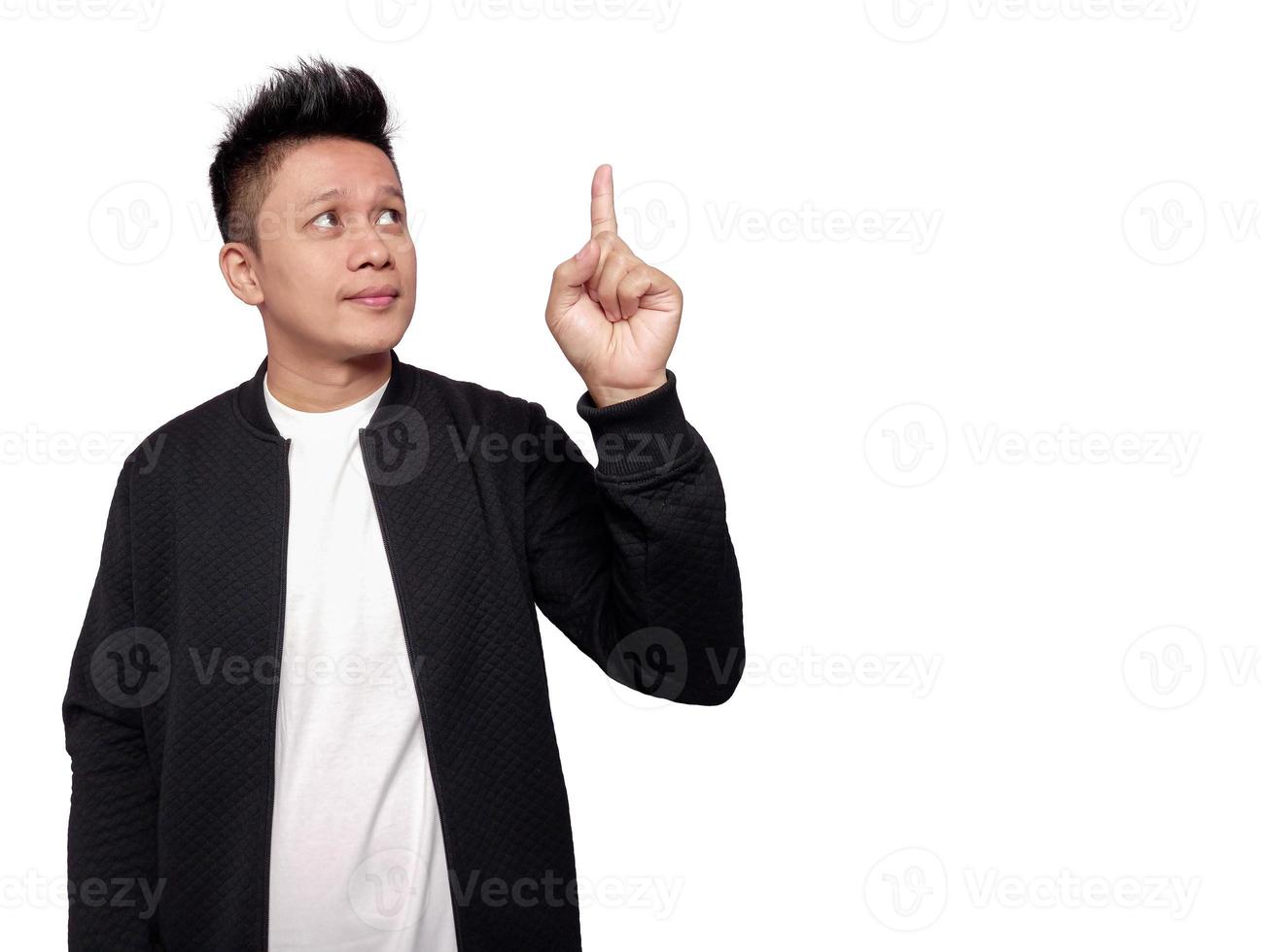 Handsome man pointing and looking up with empty space photo