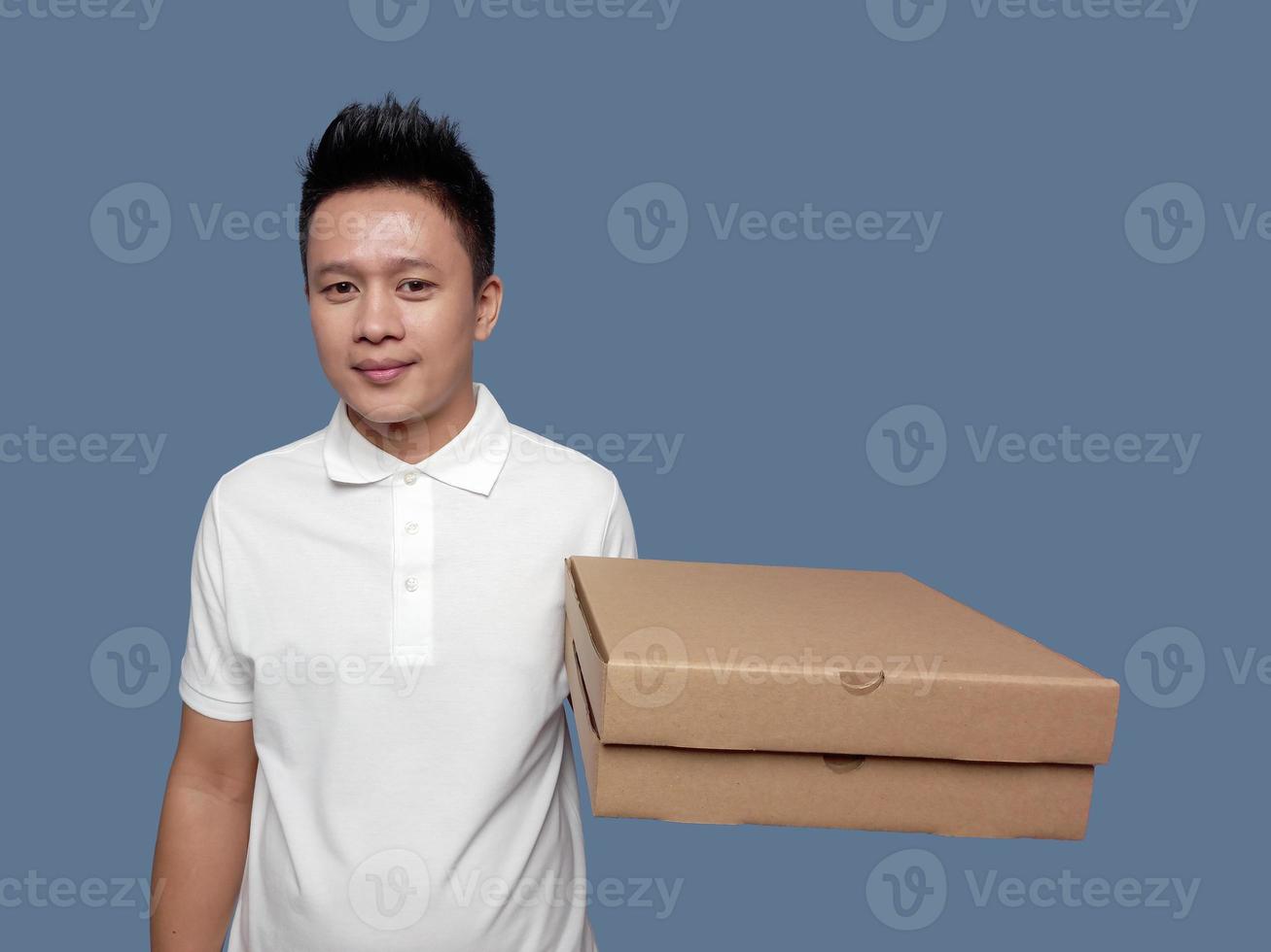 Man holding cardboard pizza box with one hand isolated on plain background. photo