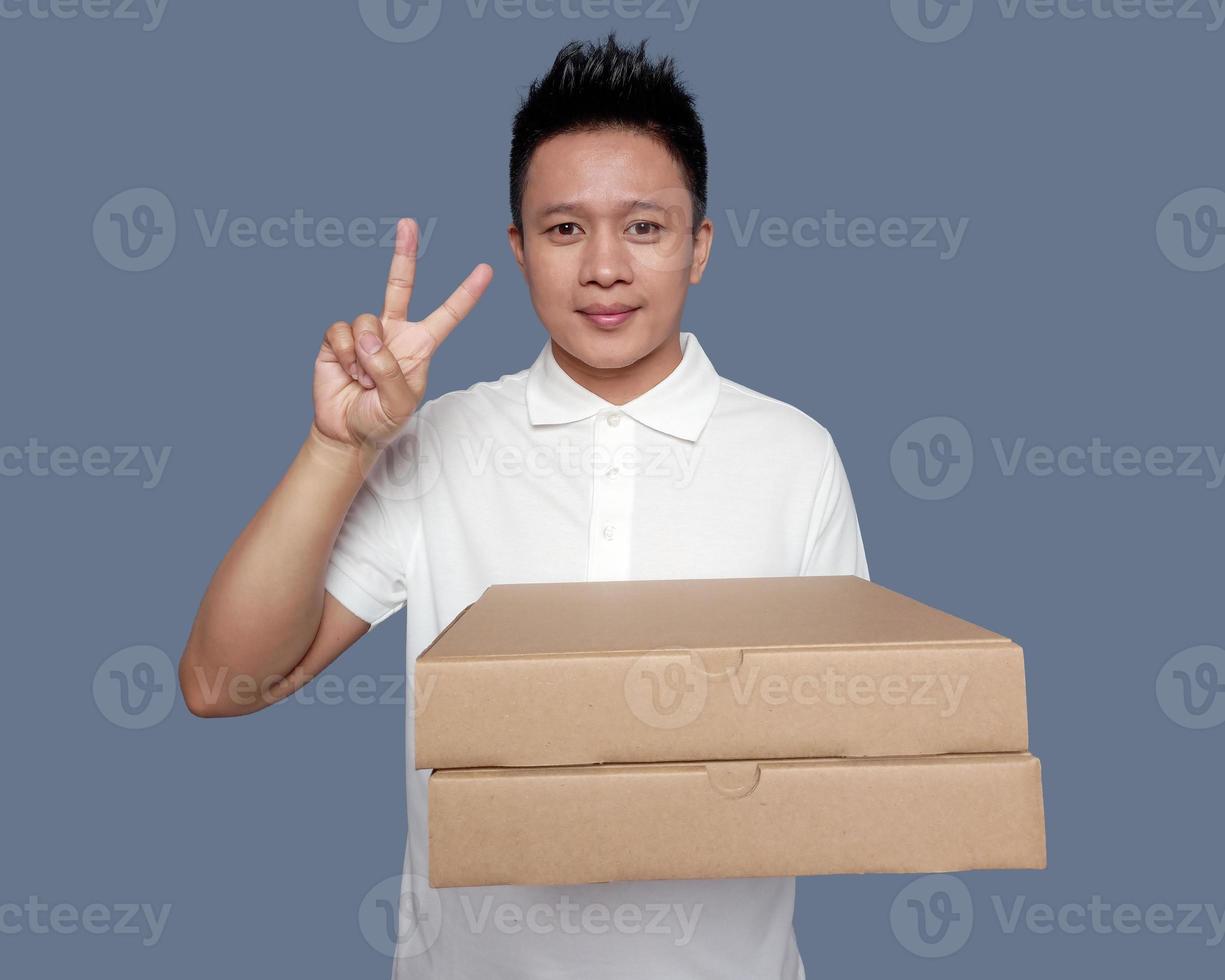 Man holding cardboard box with two finger hand gesture. photo