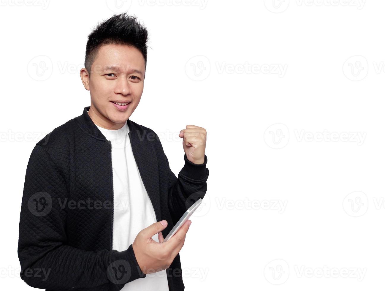 Handsome man holding mobile phone in successful gesture. photo