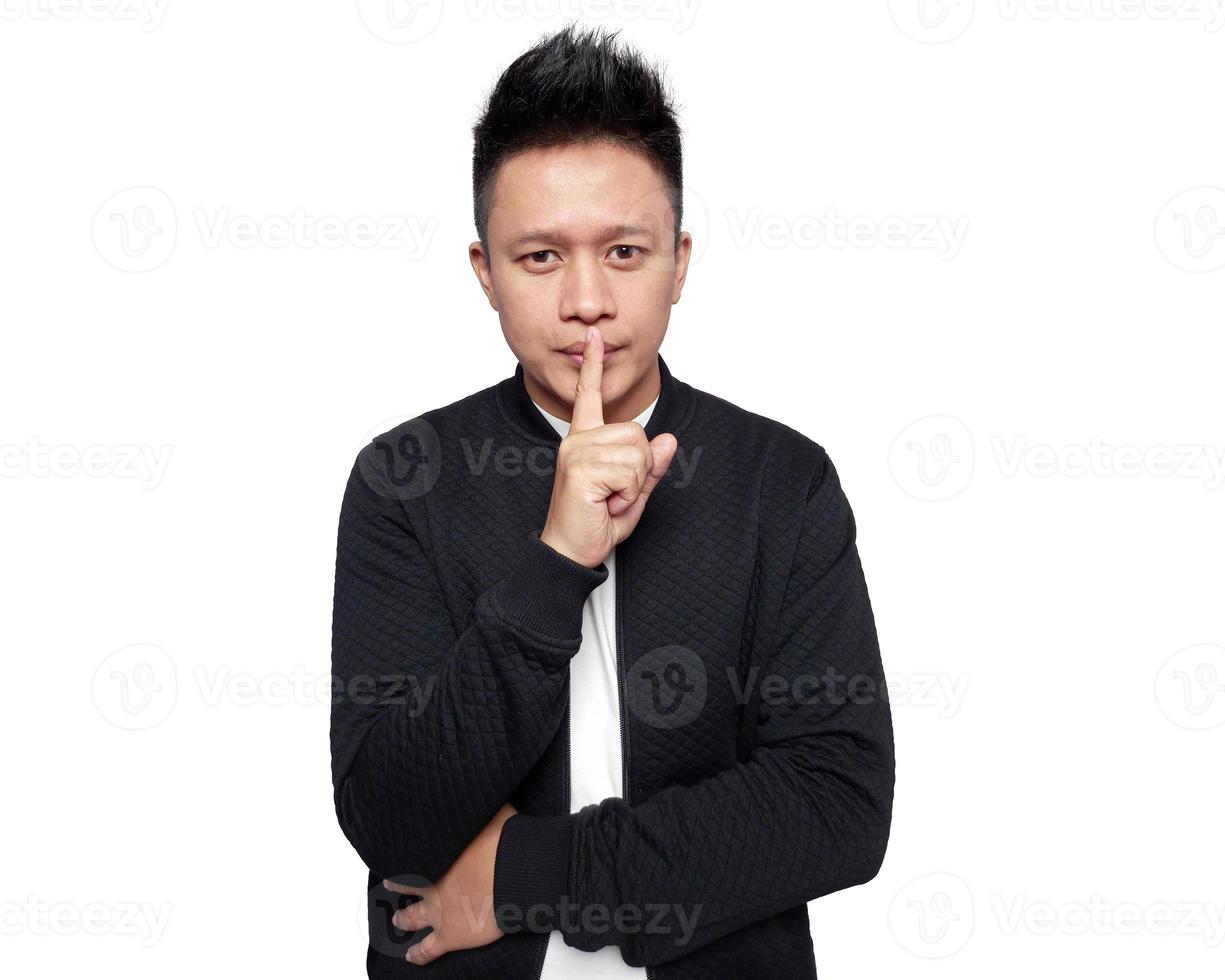Handsome man with finger on lips isolated on white photo
