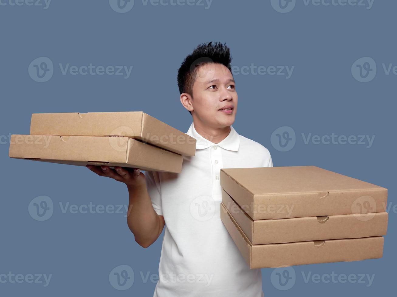 Man holding cardboard box in both hands looking up photo