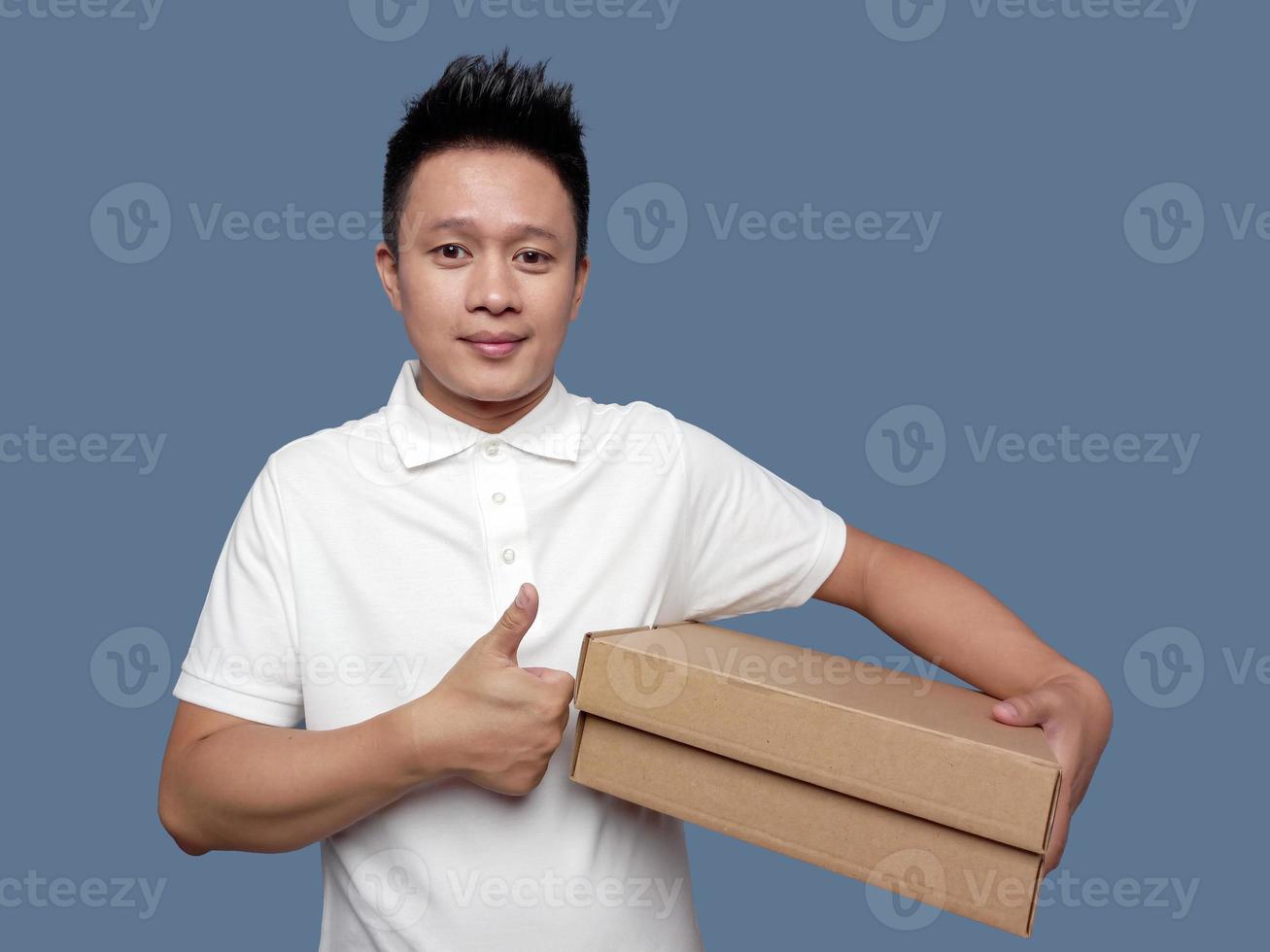 Man holding cardboard box with thumbs up gesture photo