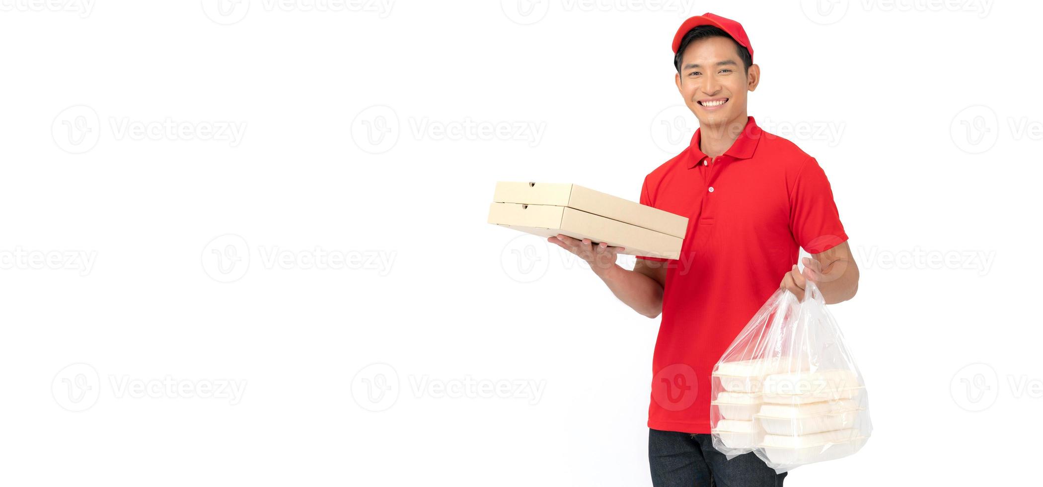 The smiling pizza delivery man stands on a white background holding the pizza box and wearing a red cap and a blank t-shirt uniform. photo