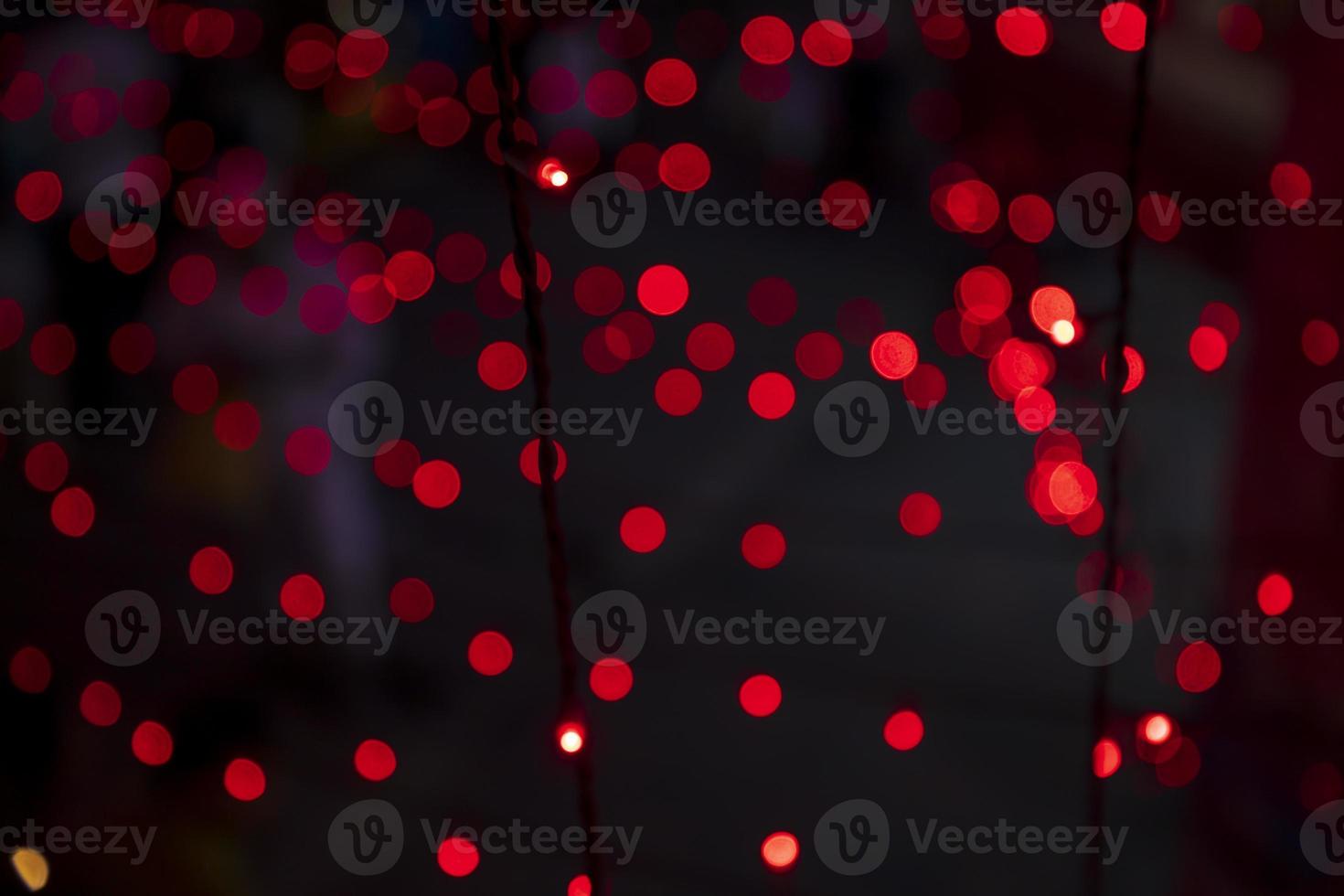 Red Defocus Abstract bokeh light effects on the night black background texture photo