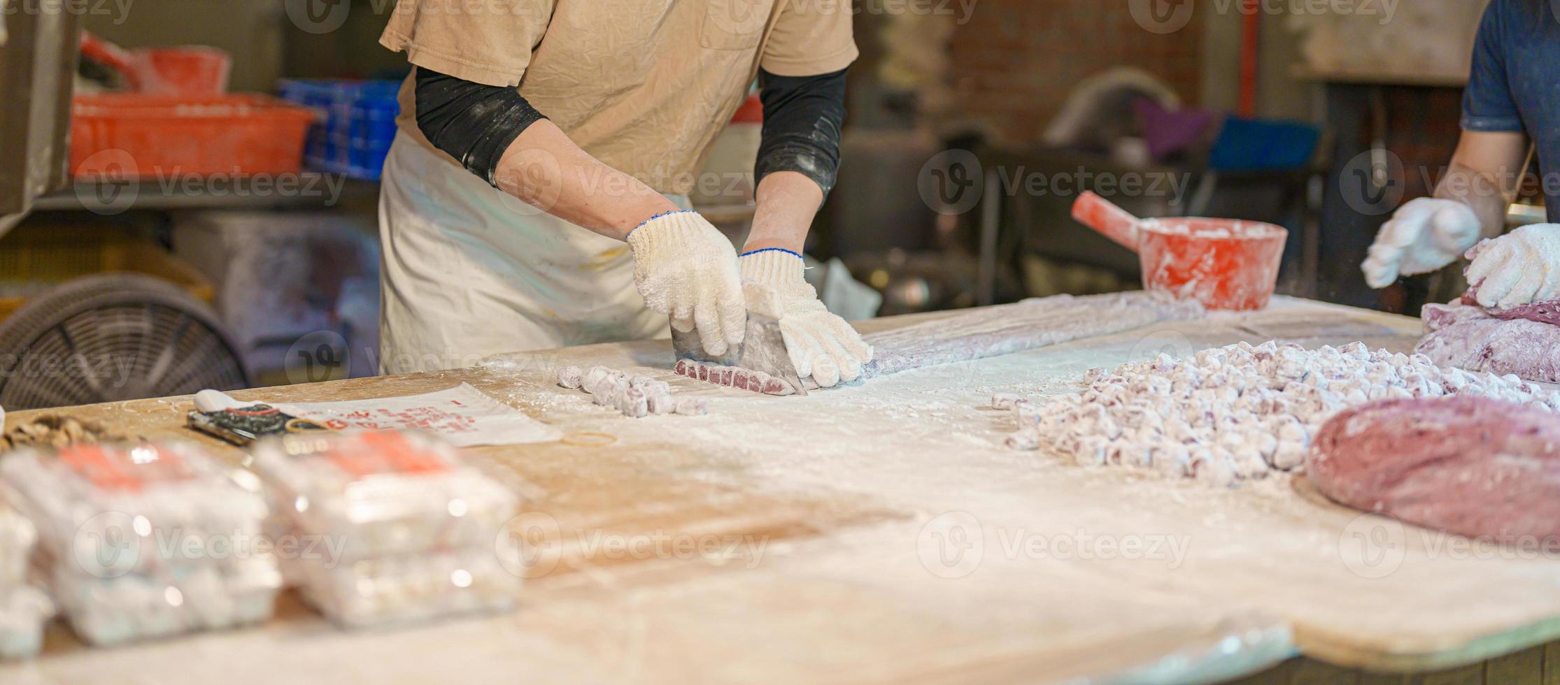 hand preparing Yu Yuan or Jiufen taro ball on the Jiufen Old Street. landmark and popular for tourists attractions near Taipei city. Street Food and Taiwan Travel Vacation concept. photo