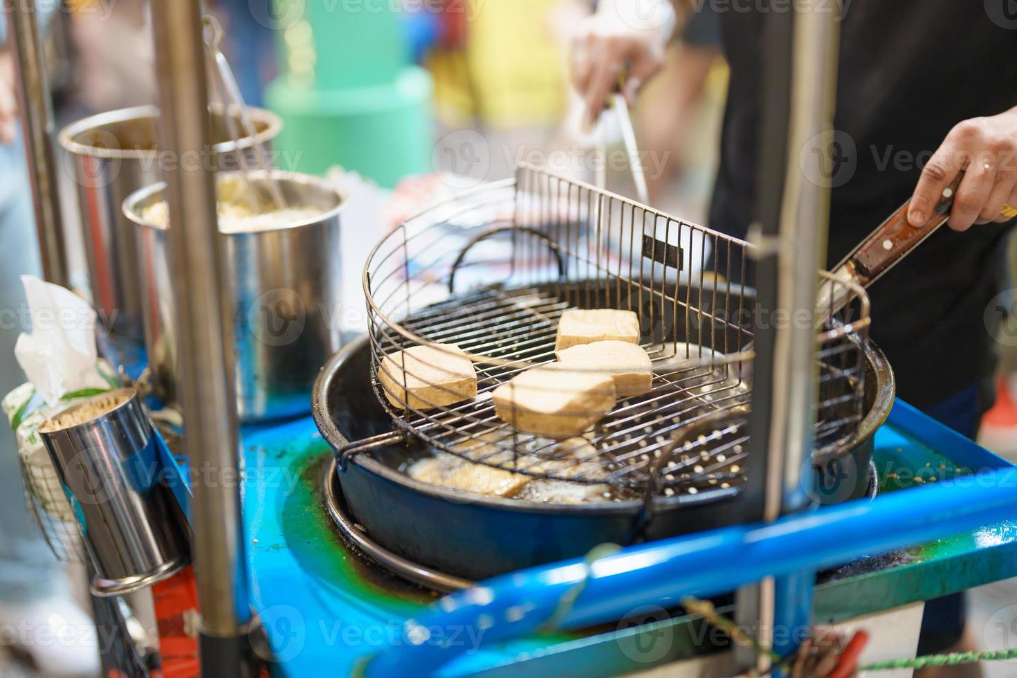 hand cooking Stinky Tofu at night market, famous Taiwanese Street Food of Taiwan. exotic food in local market photo