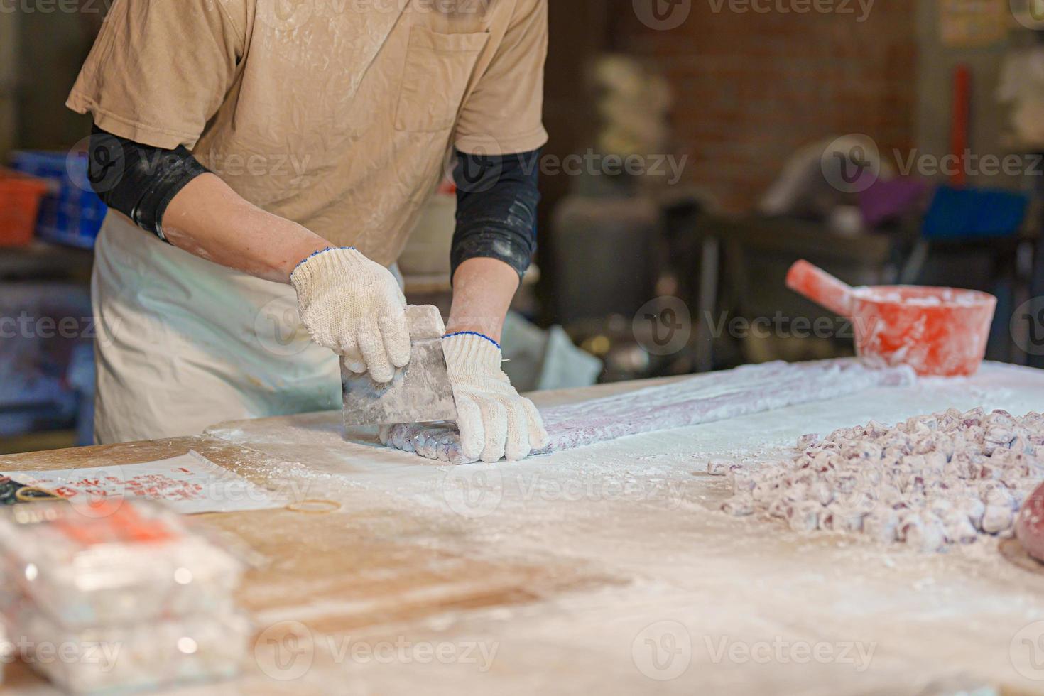 hand preparing Yu Yuan or Jiufen taro ball on the Jiufen Old Street. landmark and popular for tourists attractions near Taipei city. Street Food and Taiwan Travel Vacation concept. photo