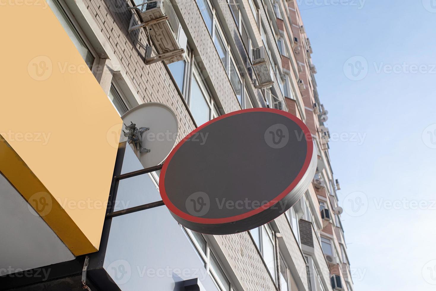 Black round logo on brick wall building exterior for mockup design photo