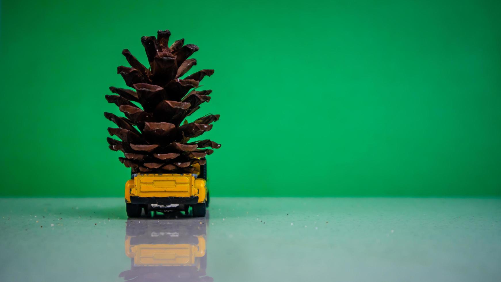 Minahasa, Indonesia  December 2022, the toy car transporting pinecones photo