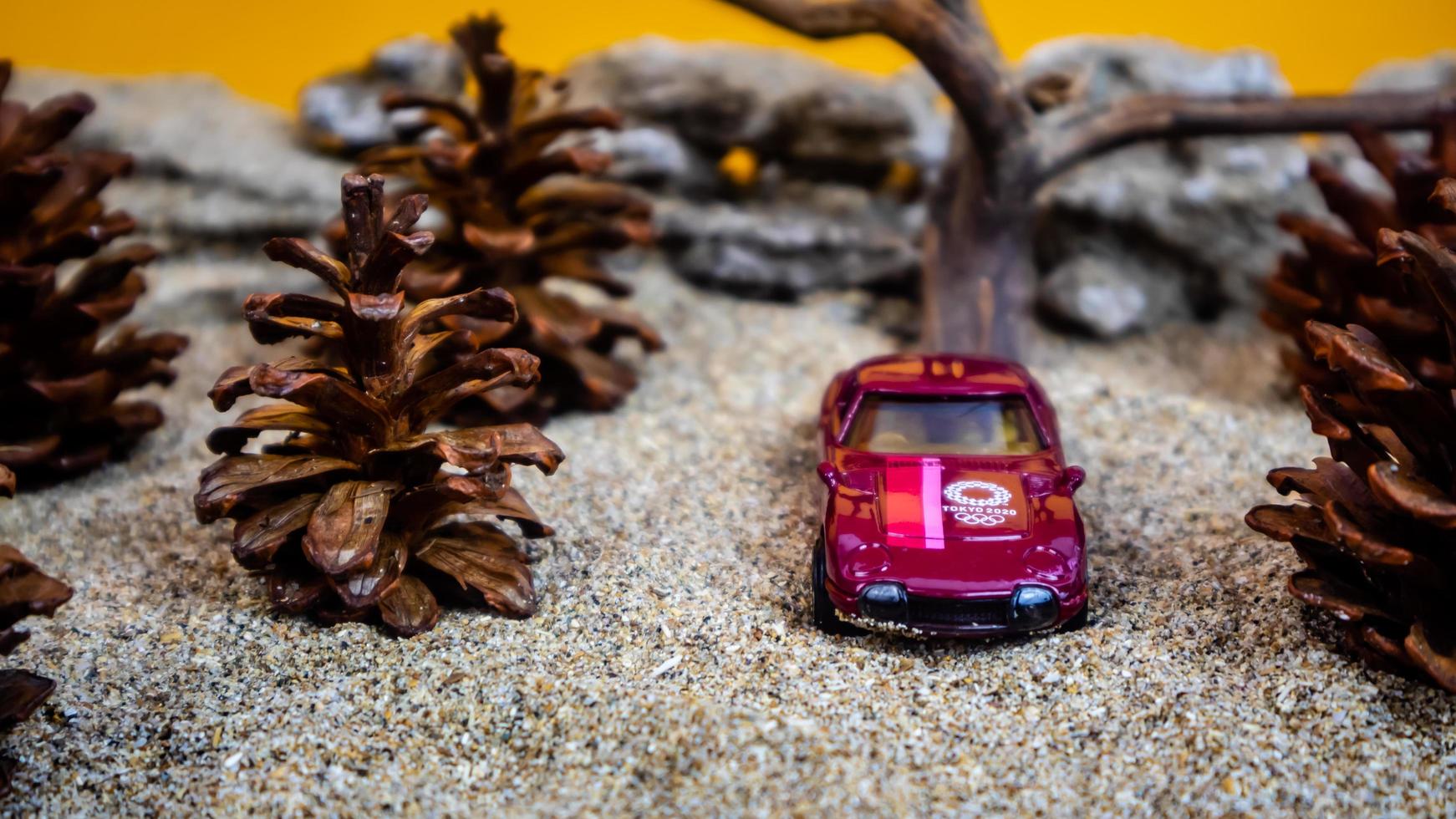 Minahasa, Indonesia  saturday, December 2022, a toy car among the pinecones photo