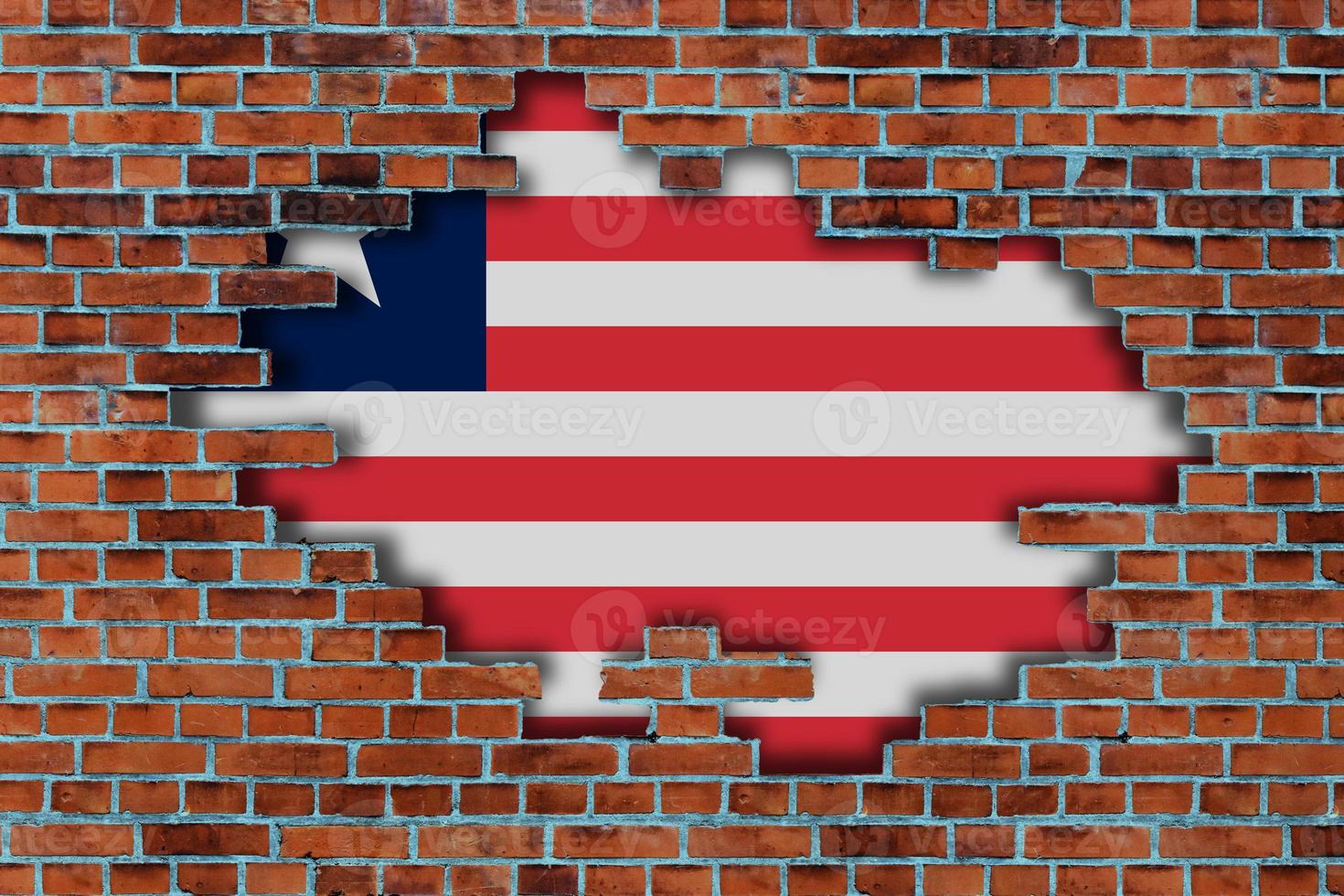 3D Flag of Liberia behind the broken old stone wall background. photo