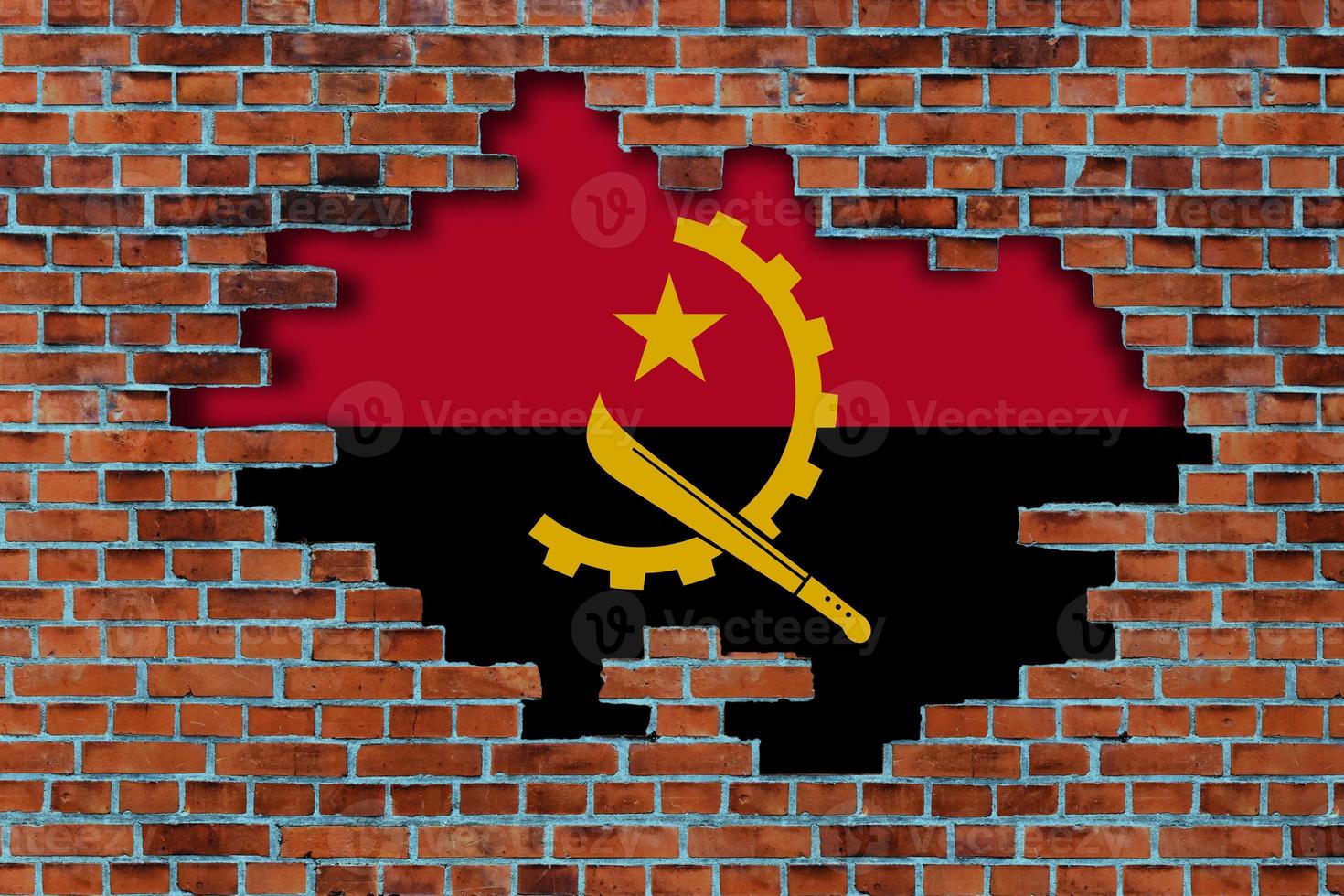 3D Flag of Angola behind the broken old stone wall background. photo