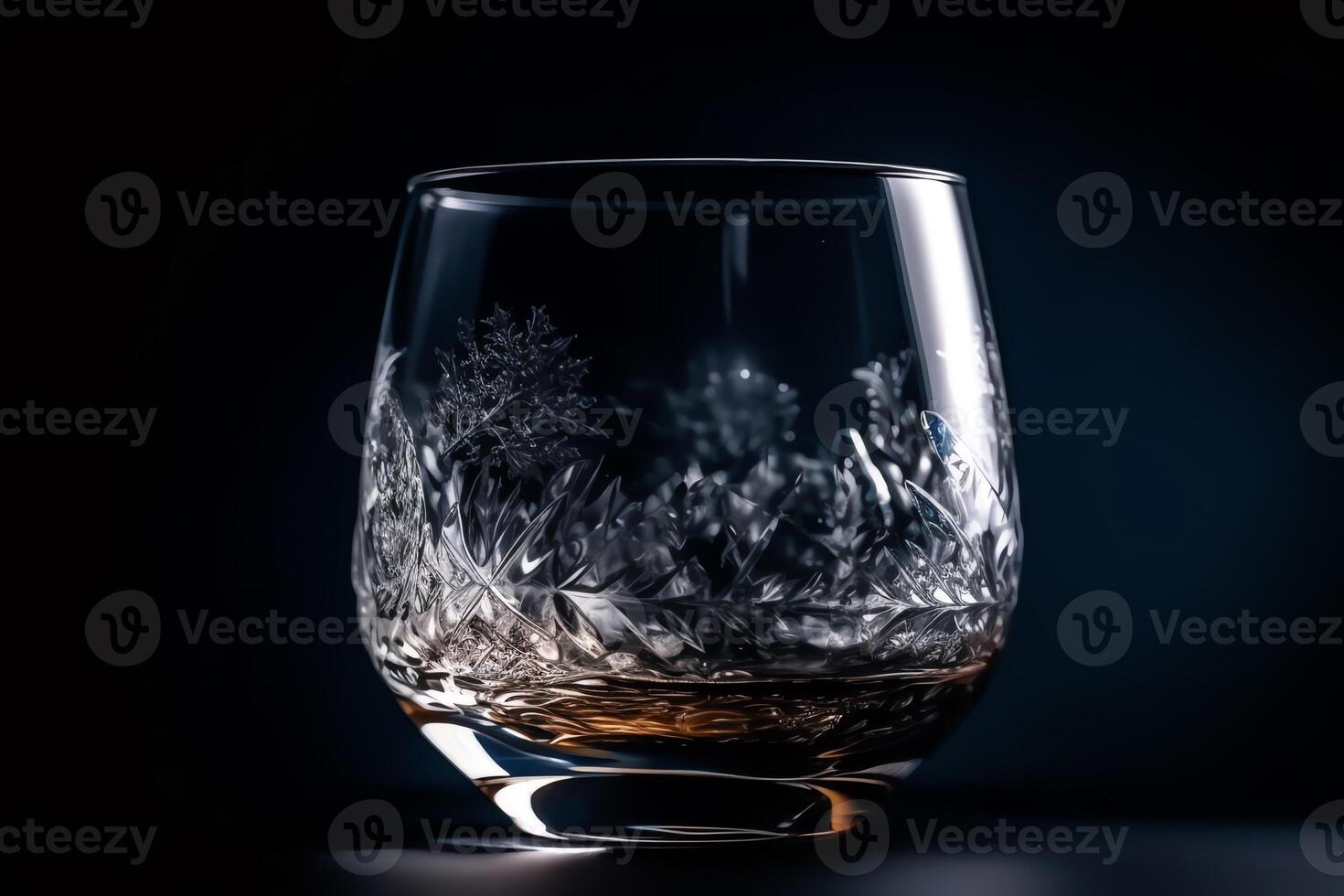 Beautiful white whiskey glass on dark blue background with ice. photo