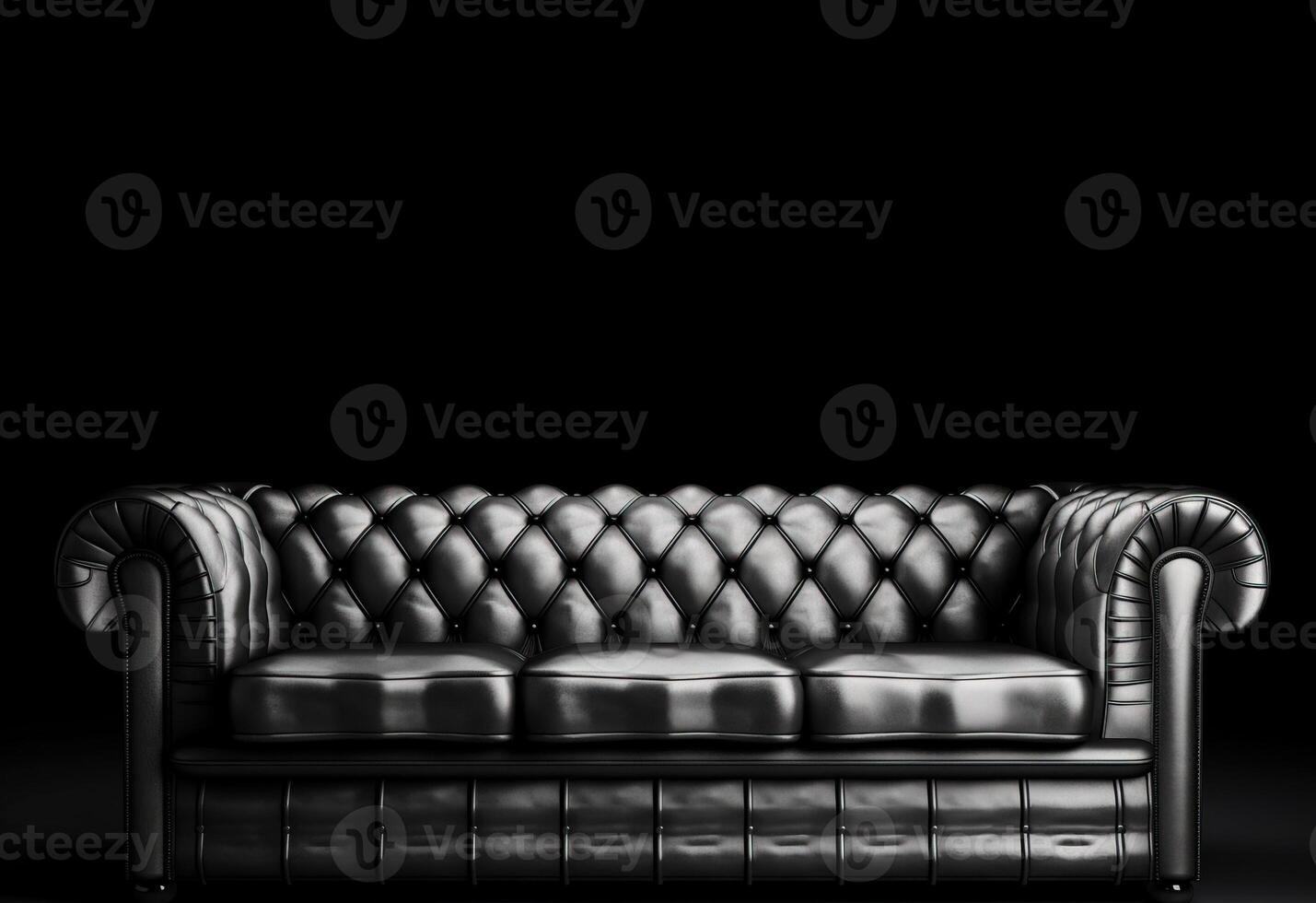 Chesterfield sofa made of black leather on a dark background, isolate. . photo