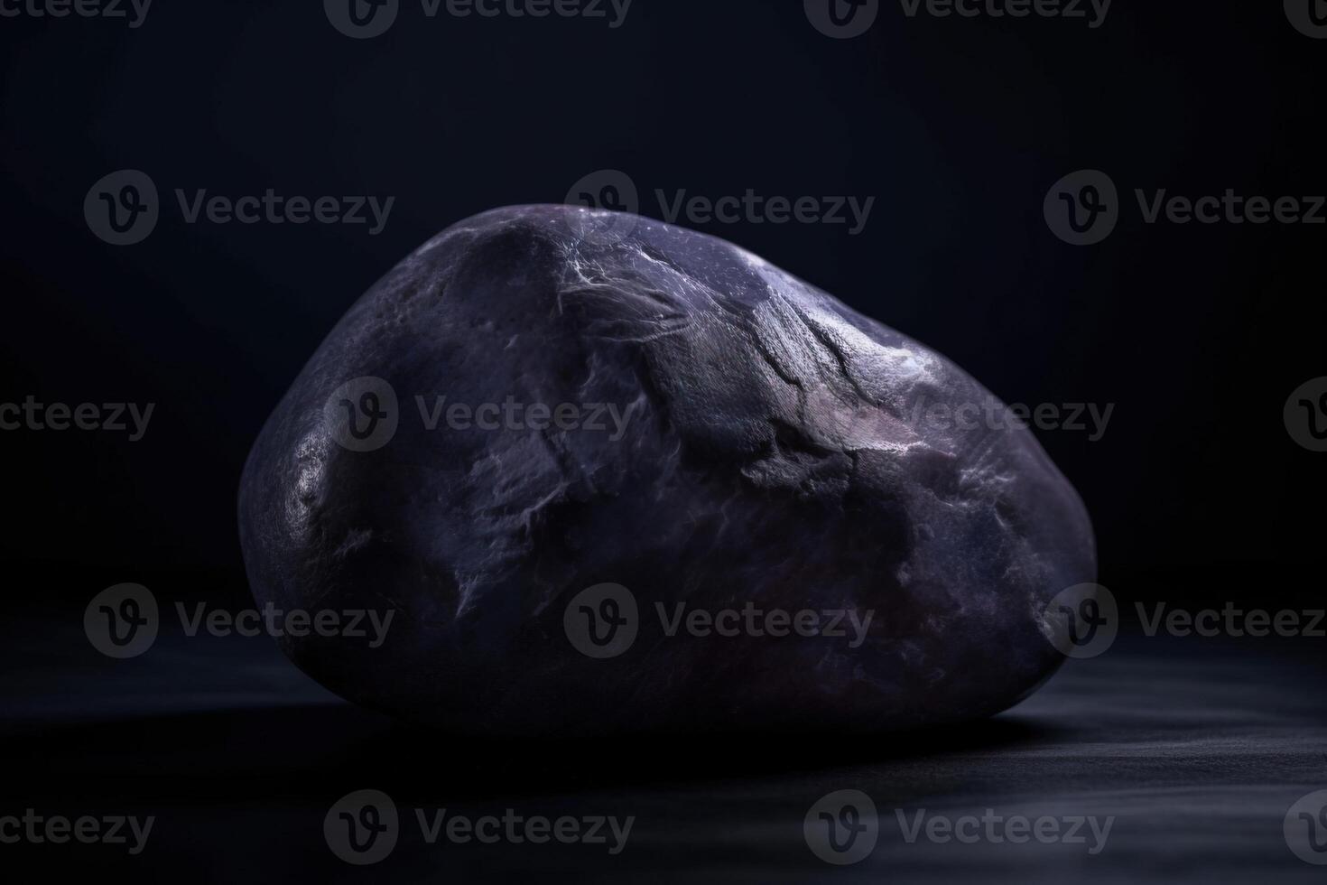 taafeito es un raro precioso natural geológico Roca en un negro antecedentes en bajo llave. ai generado. foto