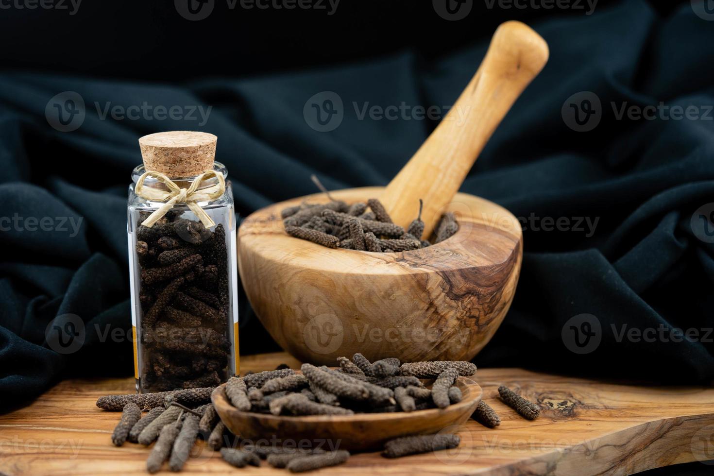 long pepper on olive wood photo