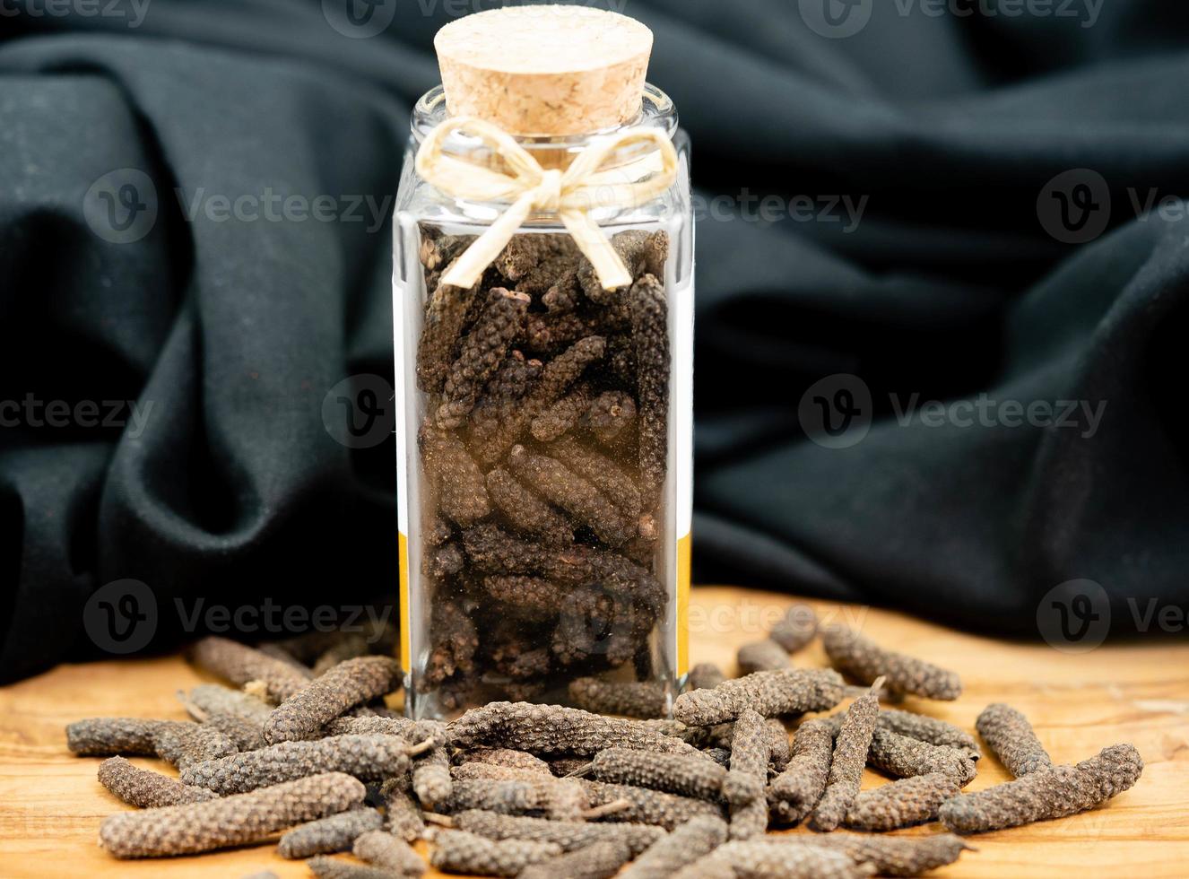 long pepper on olive wood photo