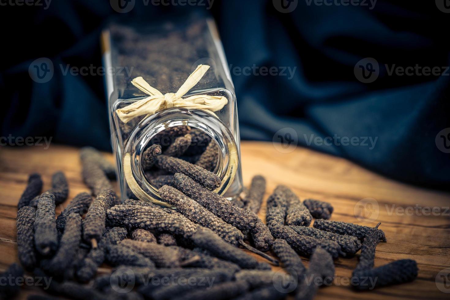 long pepper on olive wood photo