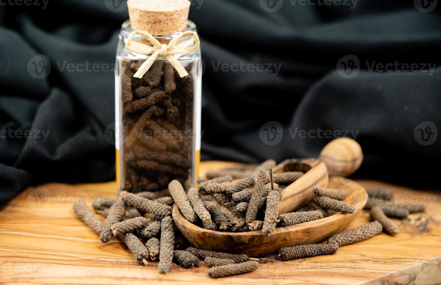 long pepper on olive wood photo