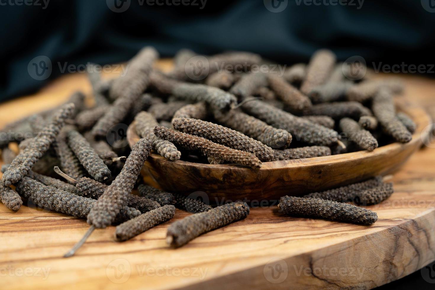 long pepper on olive wood photo