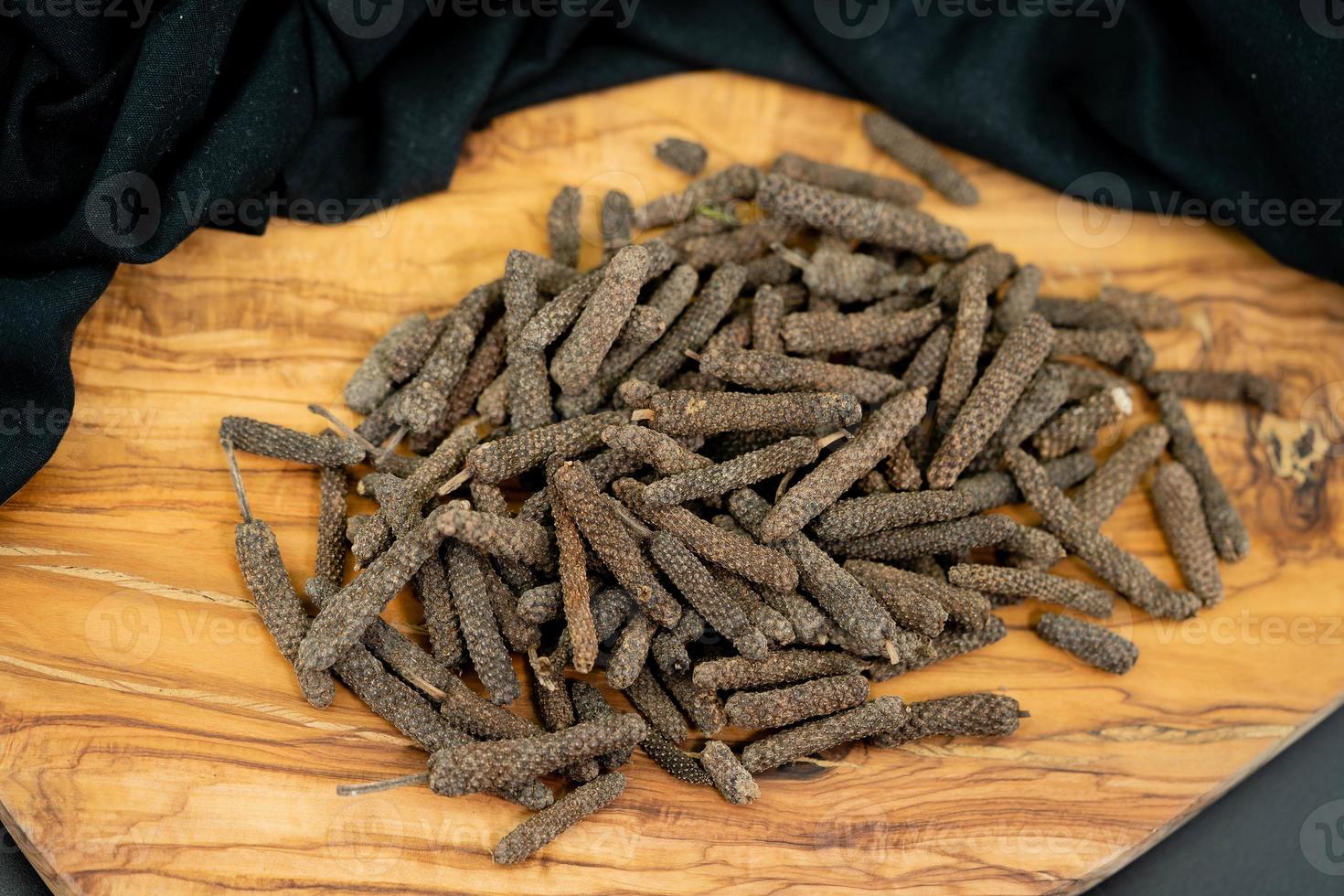 long pepper on olive wood photo