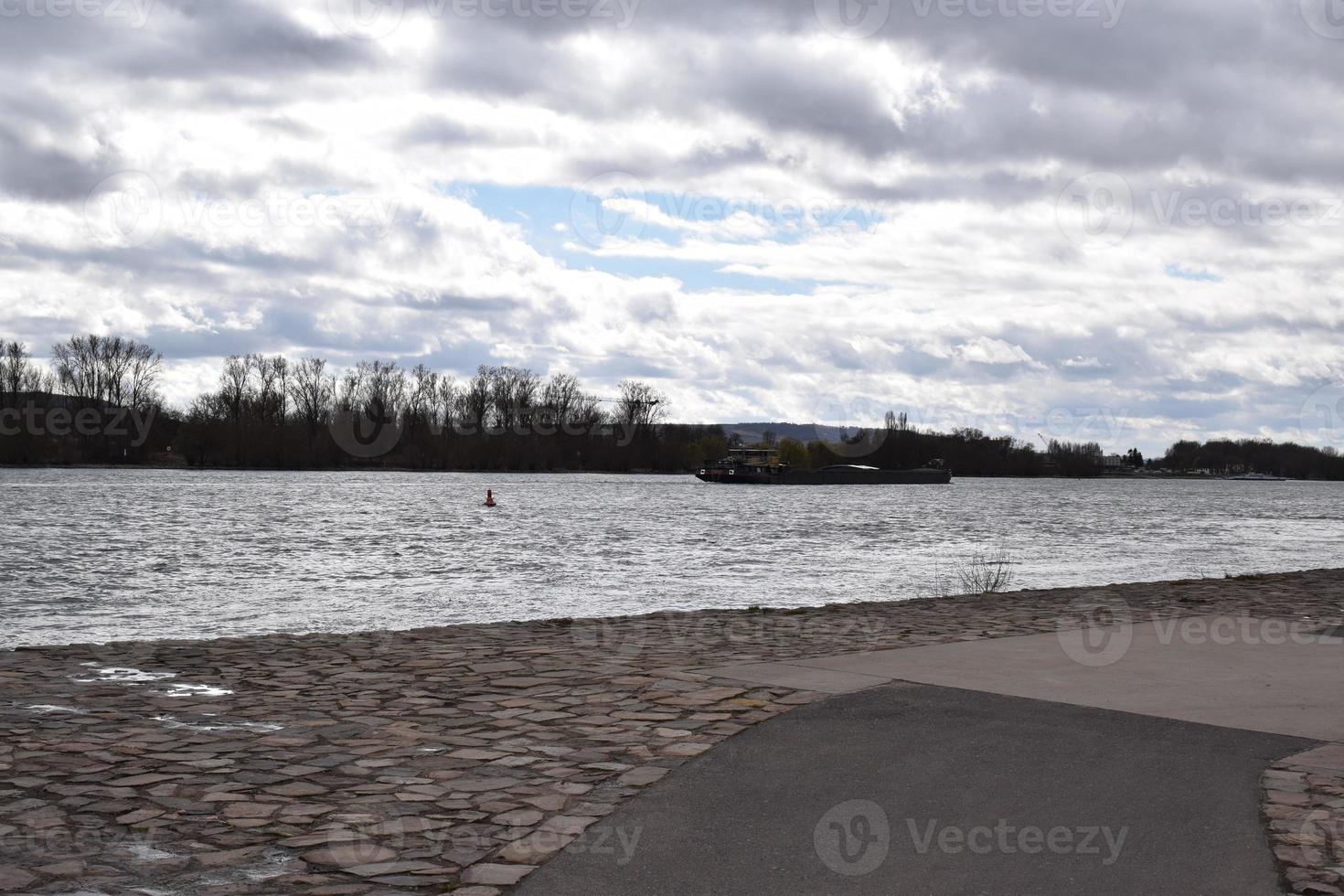 Stone Waterfront at the Rhine with a Ship in the Shadows photo