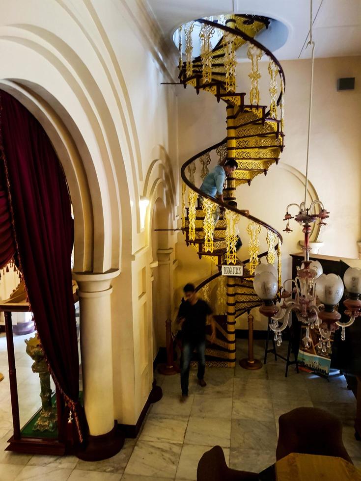 Riau, Indonesia on March 2022. The spiral staircase at Siak Palace is very luxurious photo