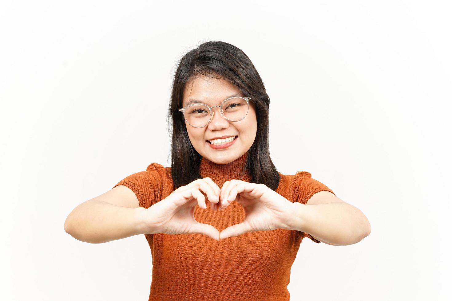 Showing Love Sign Of Beautiful Asian Woman Isolated On White Background photo