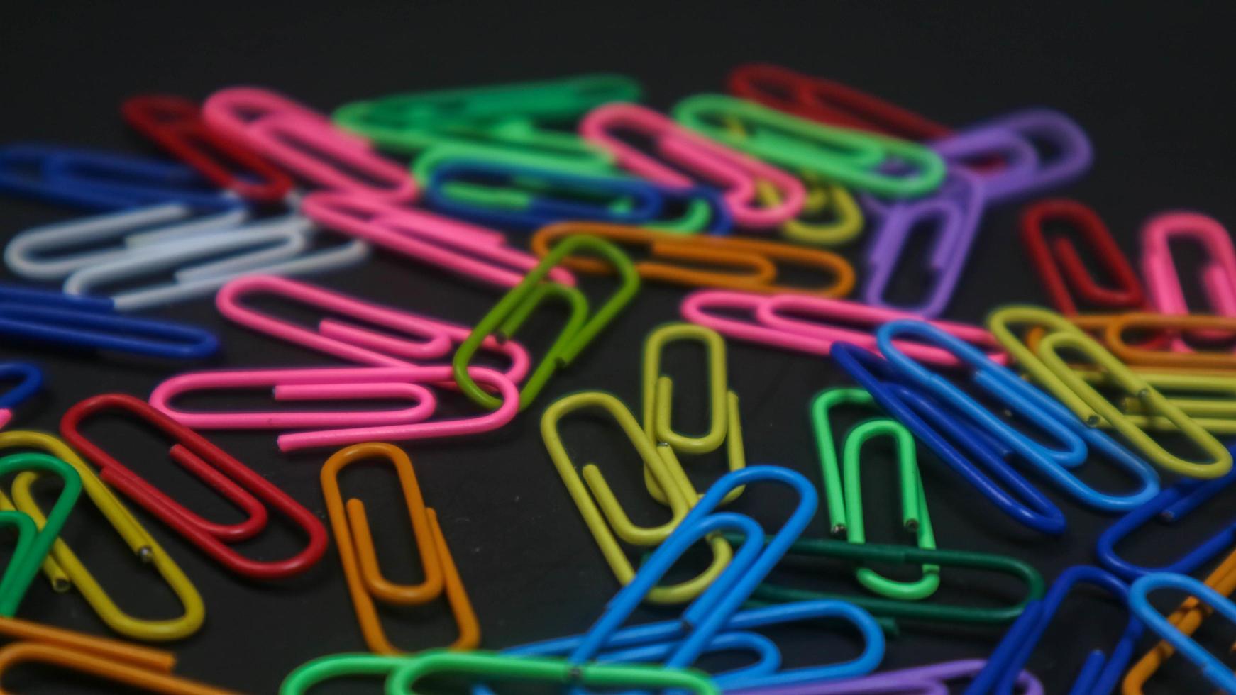 Paper clip isolated on a black background photo