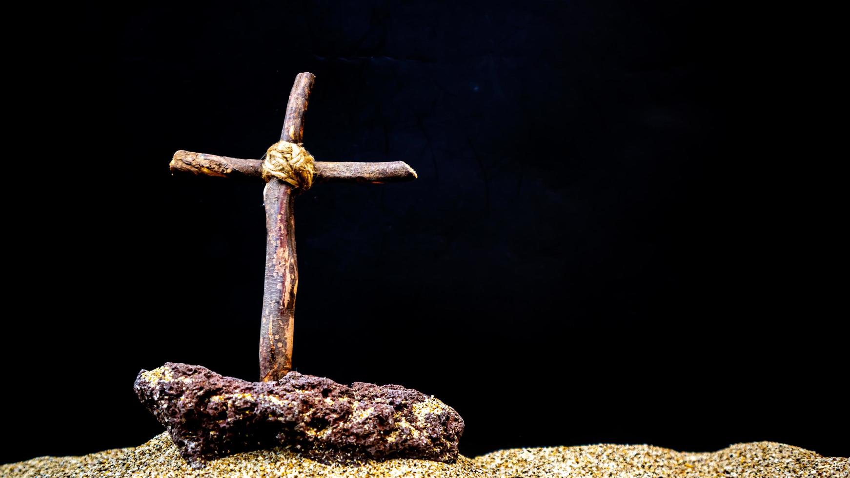 wooden cross on black background photo