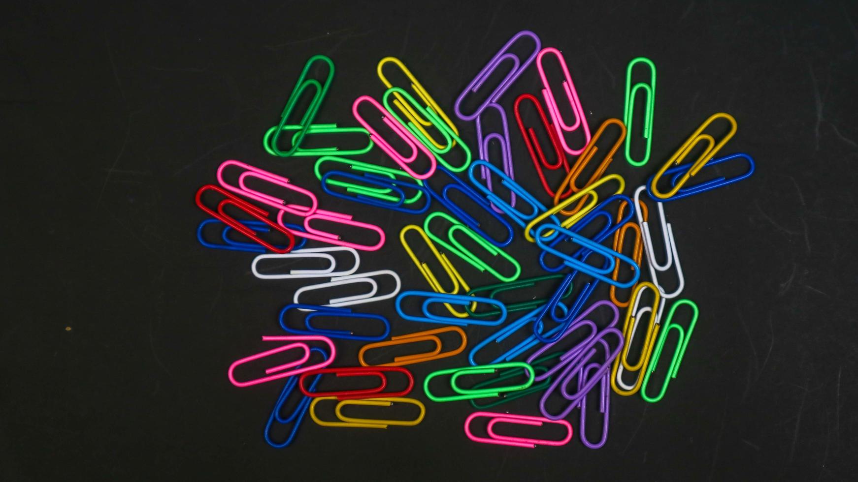 Paper clip isolated on a black background photo