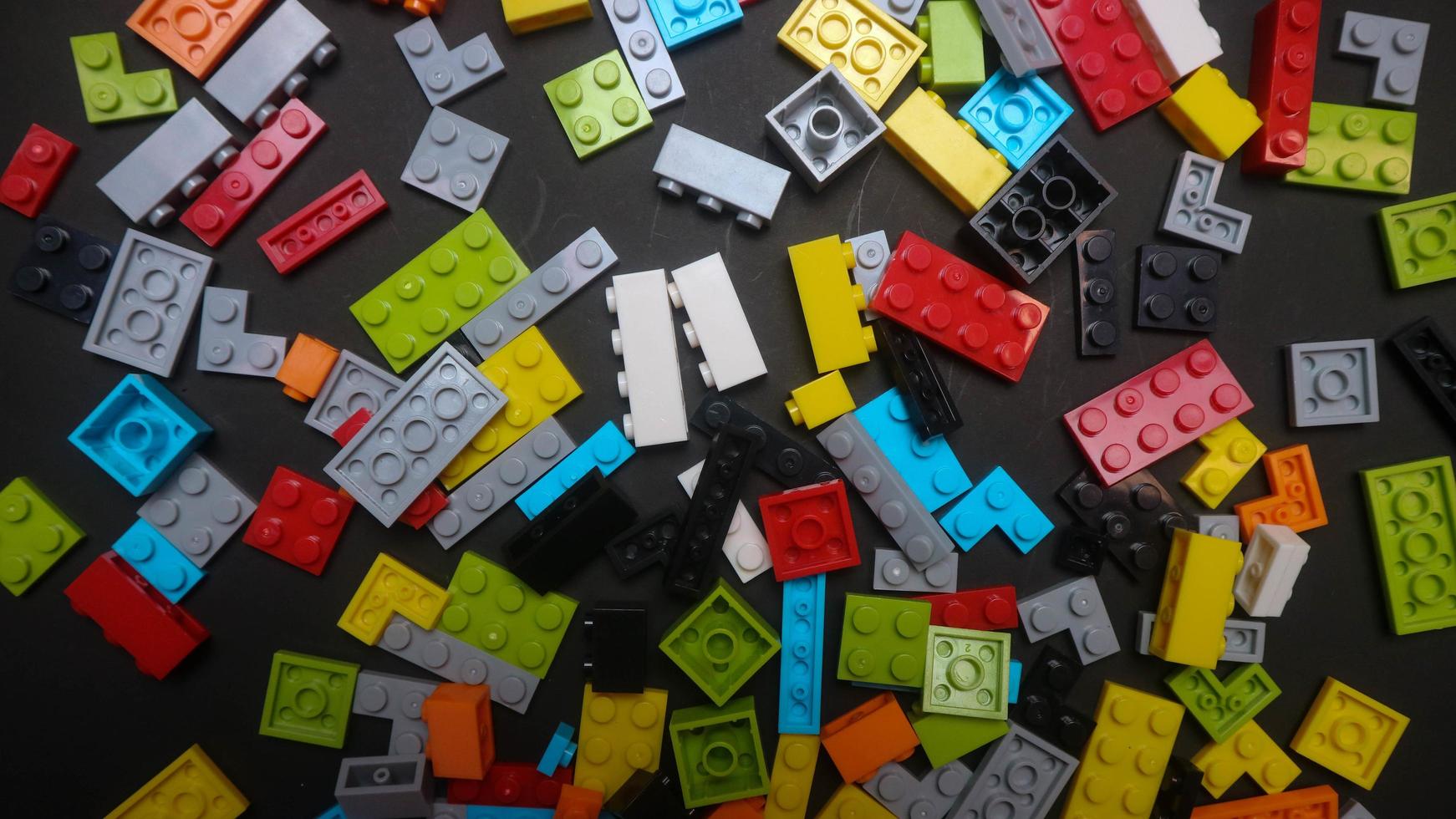 Plastic toy block on a black background photo