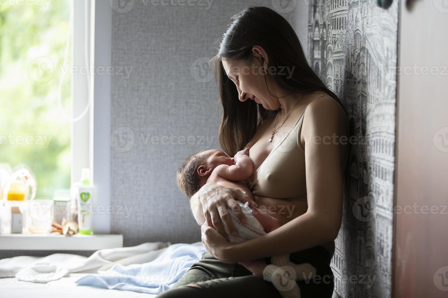 The woman is breastfeeding the baby. Breast-feeding. photo