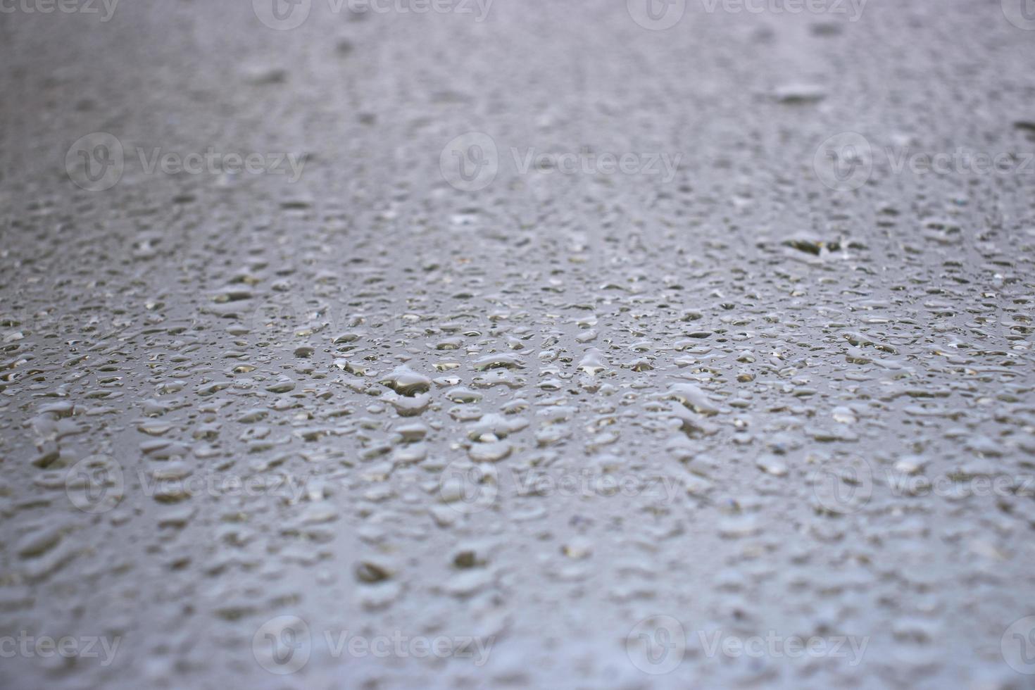 Close-up view on water drops on window in rain. Drops of rain on the glass concept photo. Front view photography with blurred background. photo