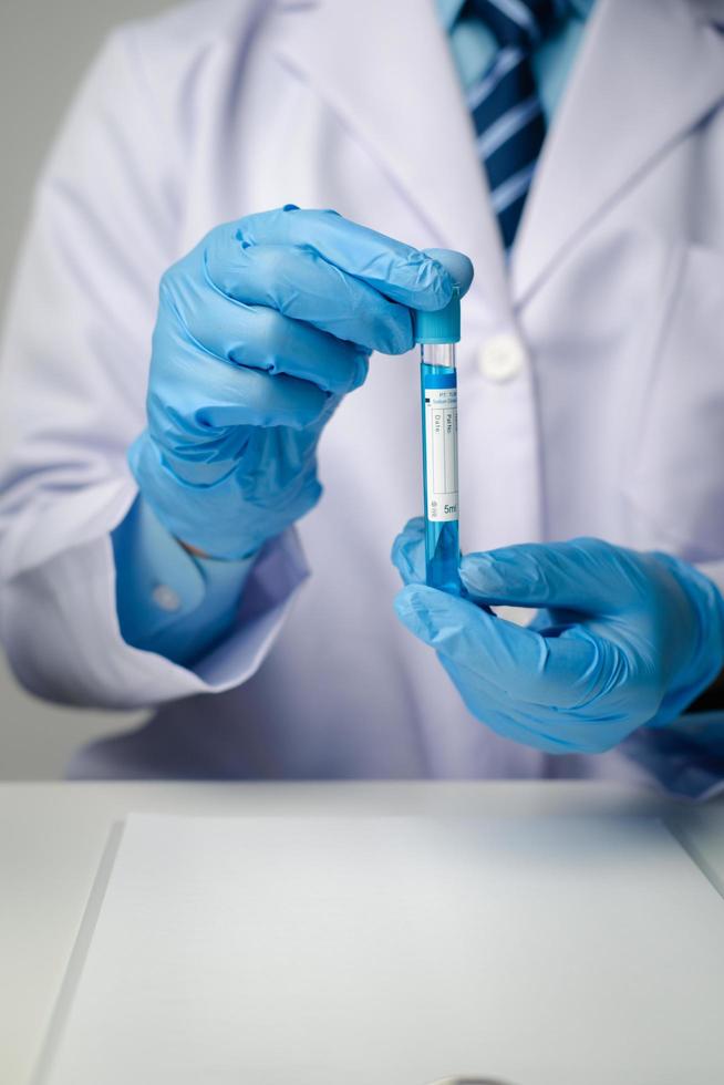 Close up view of scientist researcher showing tube glass equipment while testing substances in laboratory. photo