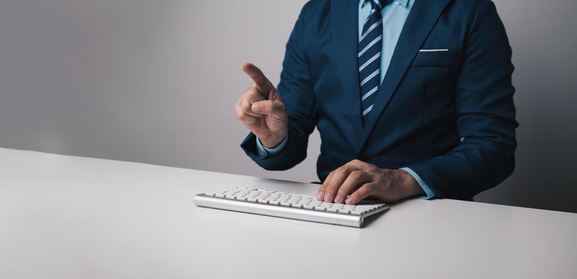 Young professional businessman typing on keyboard computer with copy space. photo