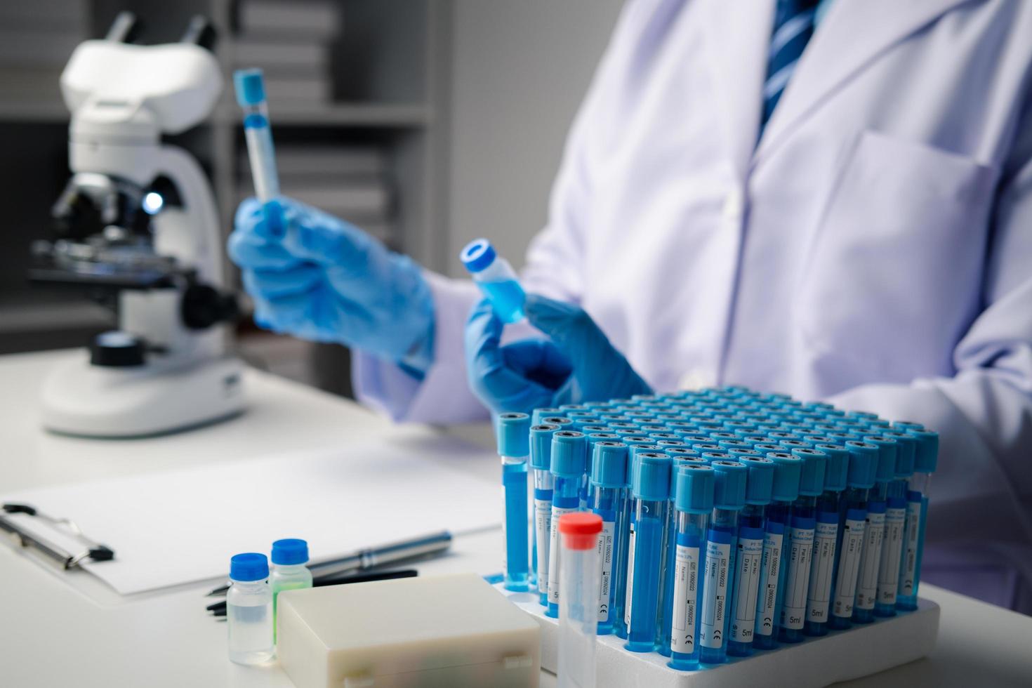 Close up view of scientist researcher testing laboratory experiment with glass equipment in the lab. photo