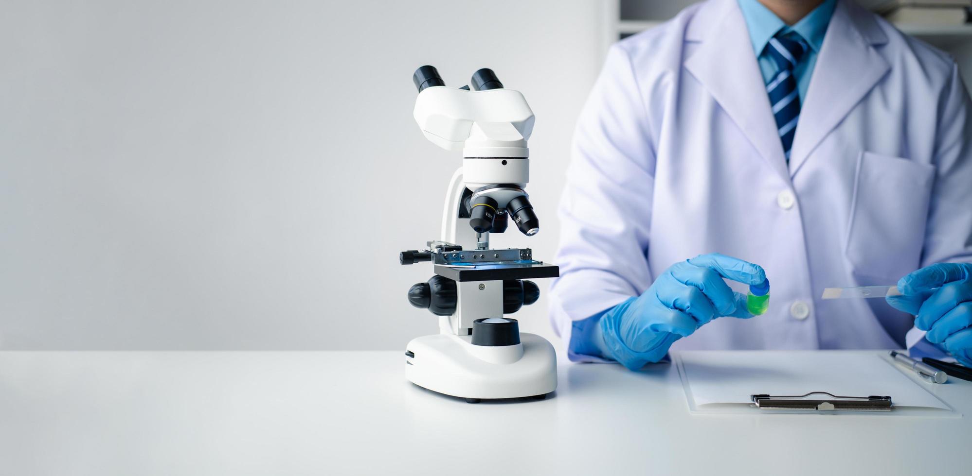 Close up view of young professional scientist performing laboratory experiments. photo