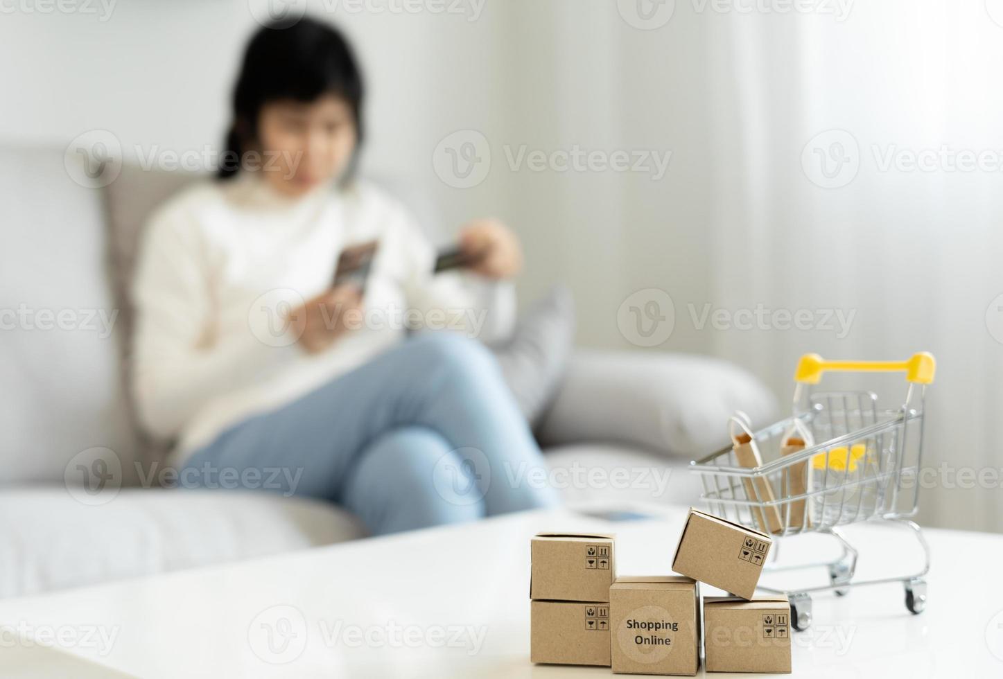woman using smartphone for online shopping at home. Hand holding mobile phone with payment detail page display and credit card, stay home, technology, electronic commerce, internet, market place photo