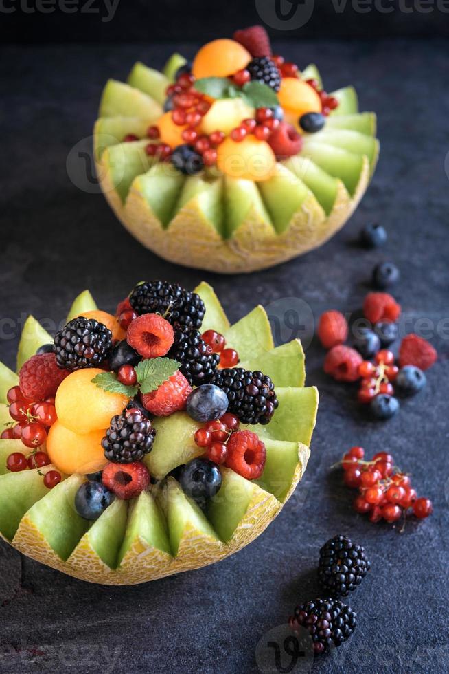 Served slice melons with berry fruits 23012531 Stock Photo at Vecteezy
