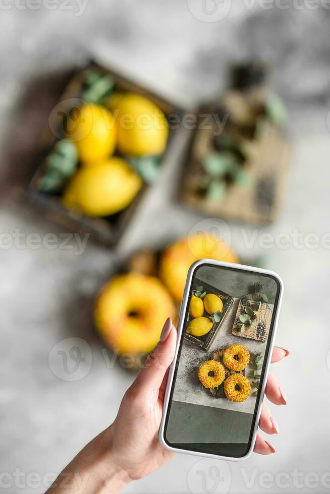 Delicious fresh donuts in yellow glaze with lemon flavor filling photo