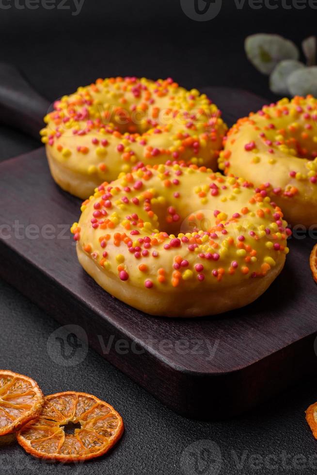 Delicious fresh donuts in yellow glaze with lemon flavor filling photo