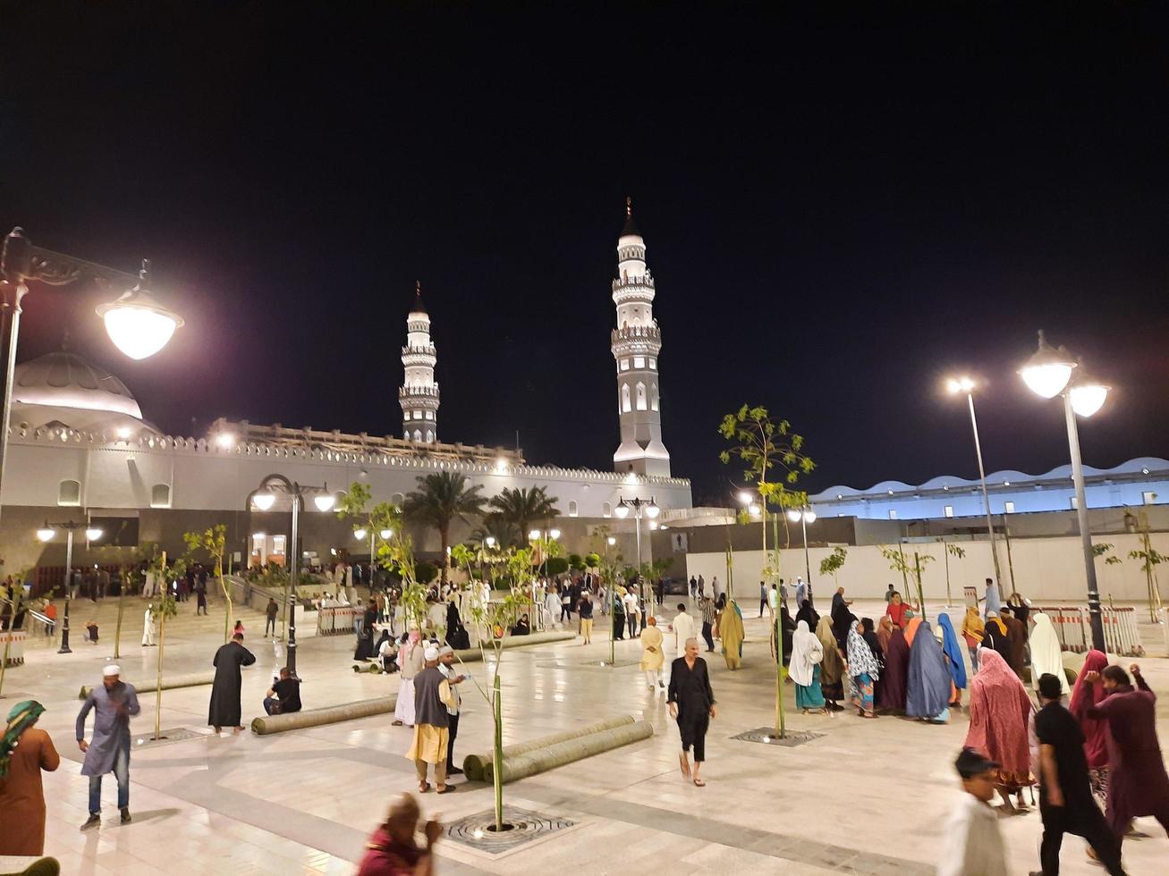 Medina, Saudi Arabia, April 2023 - A beautiful view of the building and minarets  of the Quba Mosque in Medina, Saudi Arabia at night. photo