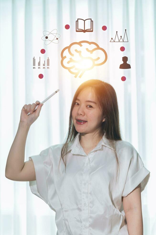 A woman is holding a drawing of a brain with the words brain on it photo