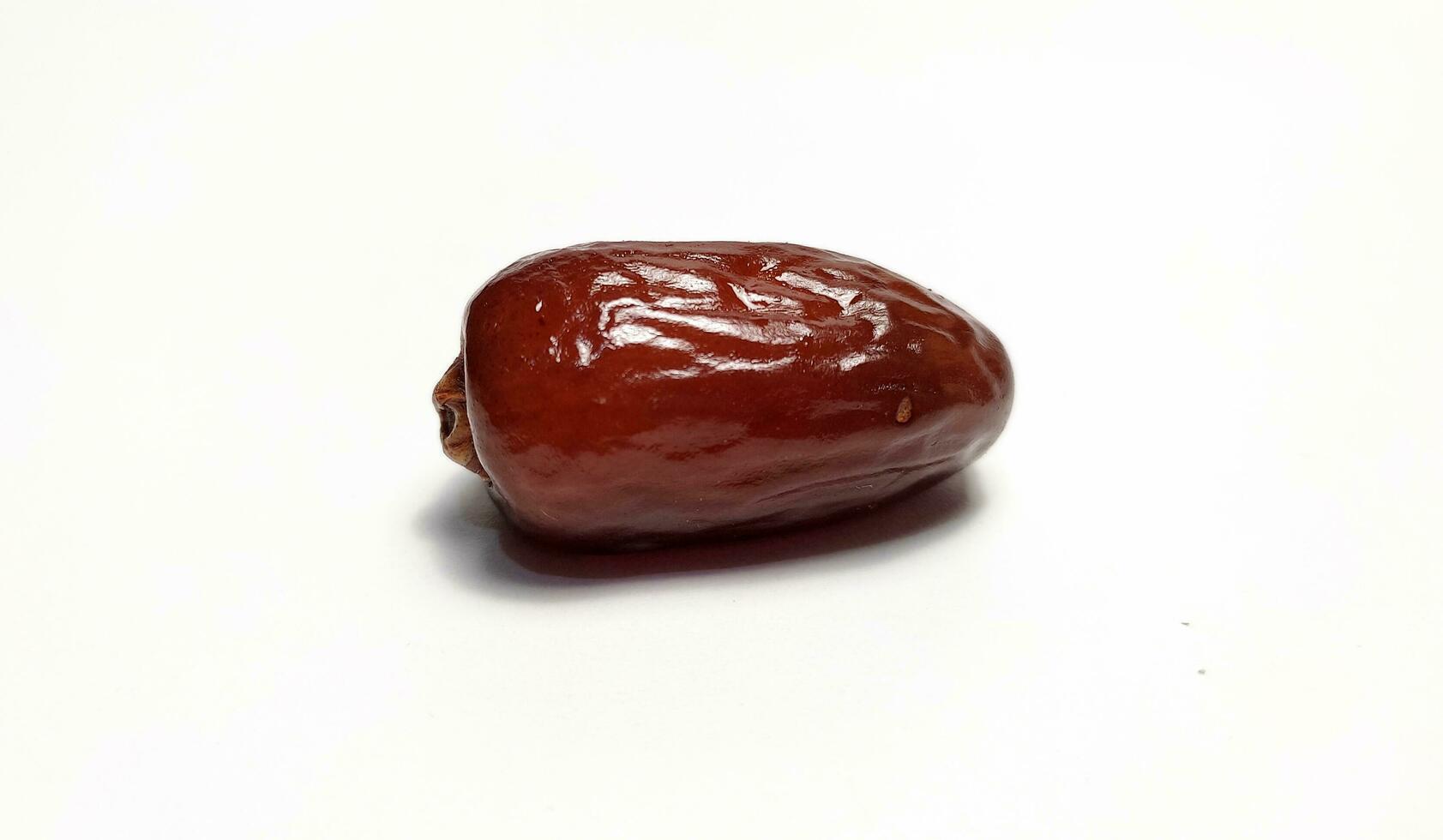 Close up of dried date fruit isolated on white background photo