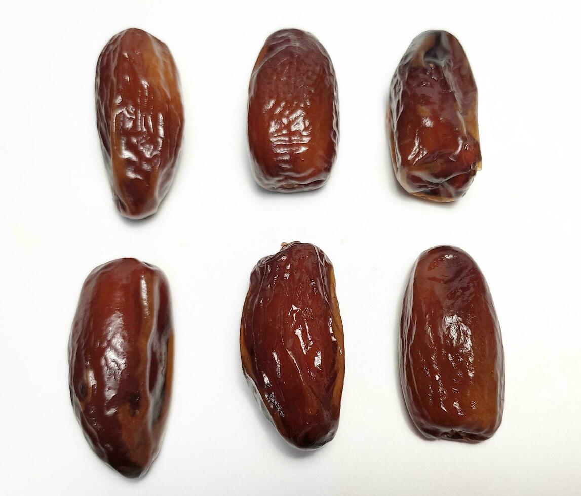 Close up of dried dates fruit isolated on white background photo