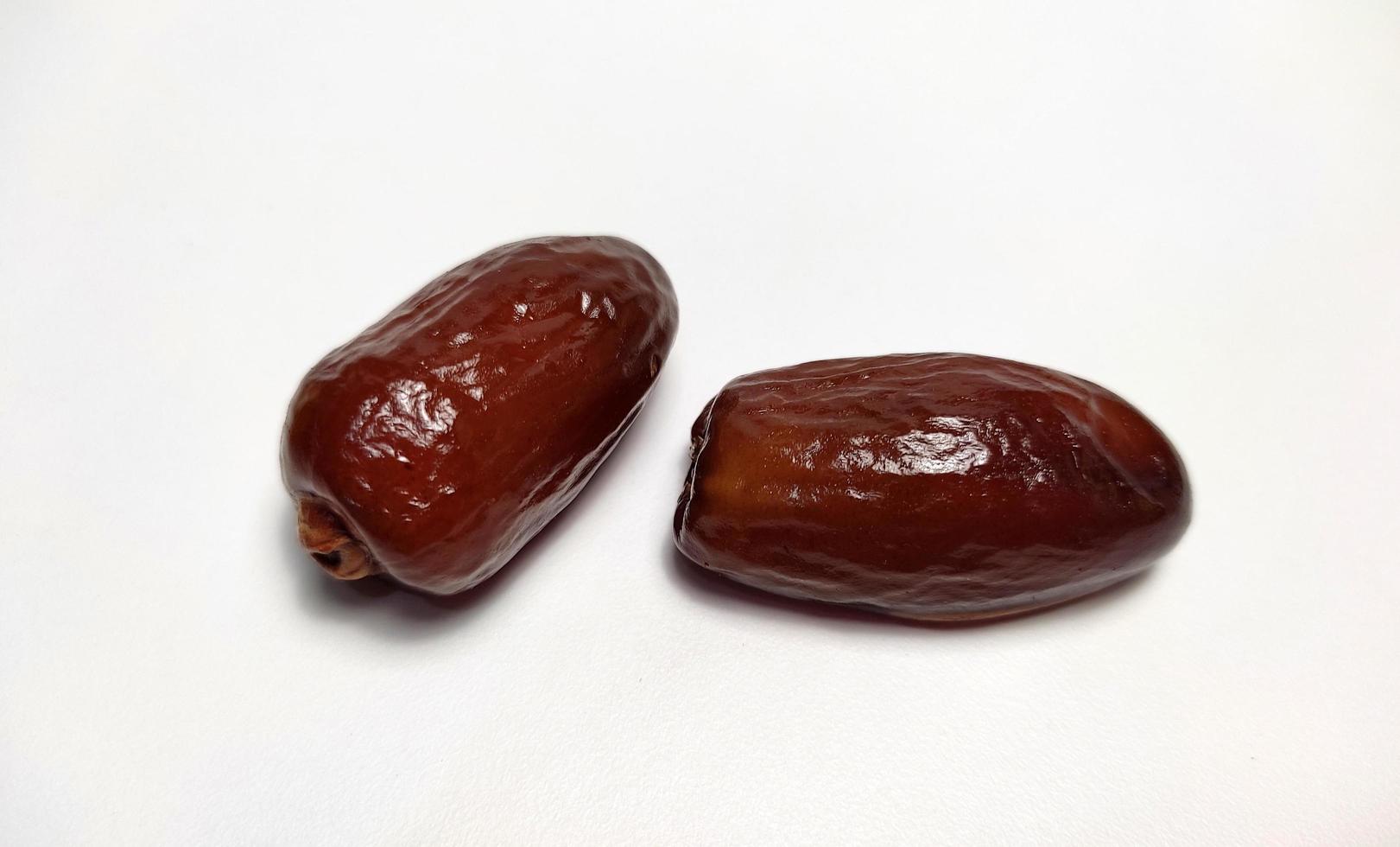 Close up of dried dates fruit isolated on white background photo