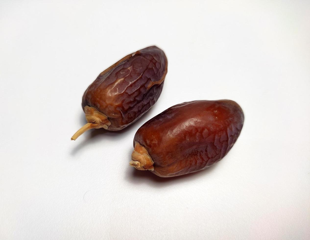 Close up of dried dates fruit isolated on white background photo