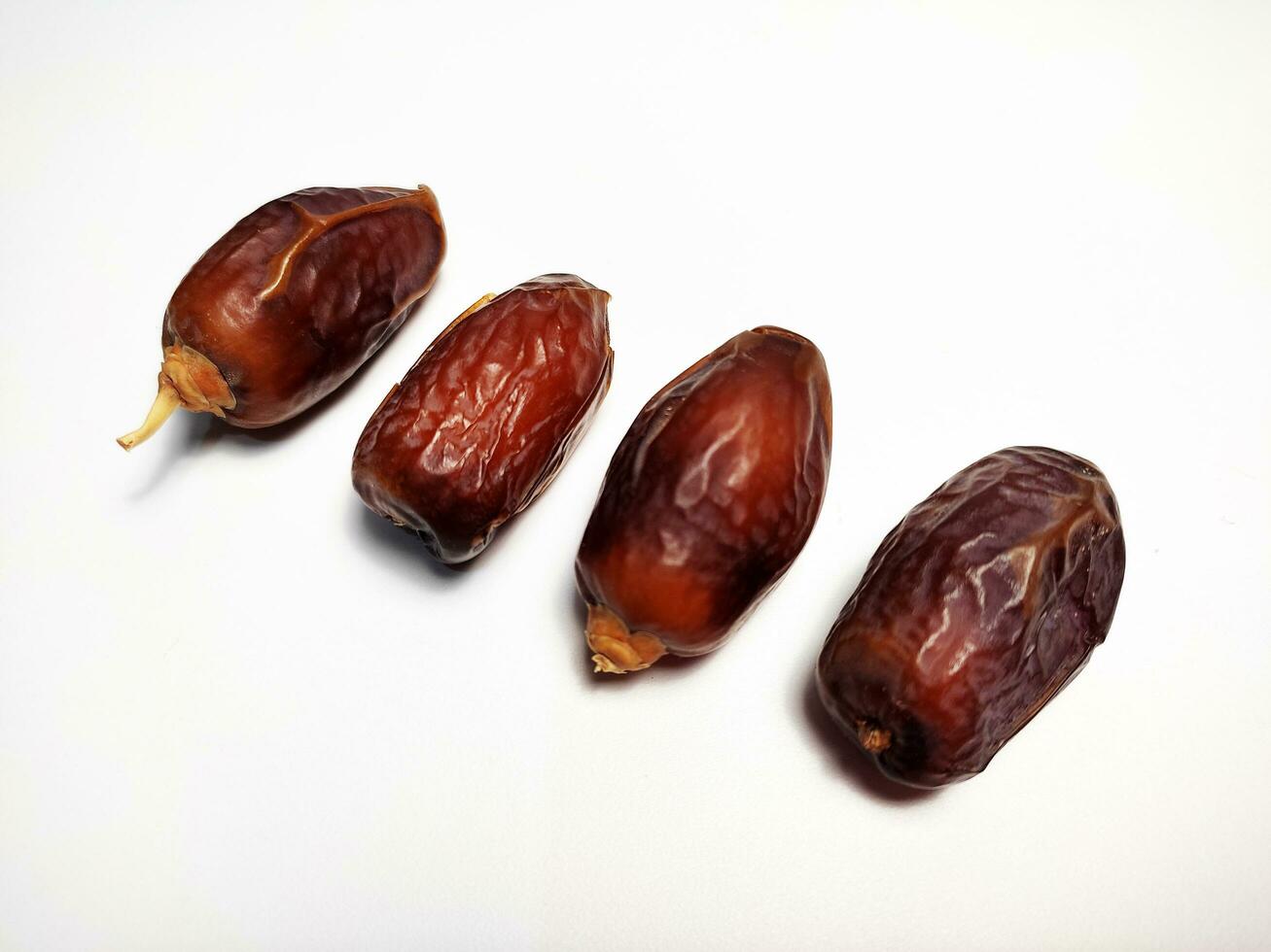 Close up of dried dates fruit isolated on white background photo